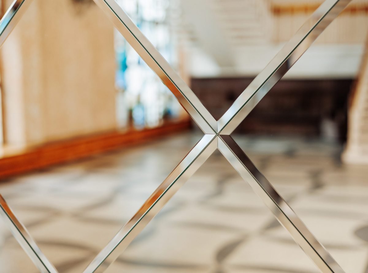 luxury mirror wall with crystals, decoration and reflection. Abstract glass background. Hotel or apartment interior. Polygonal surface. Close-up. Texture